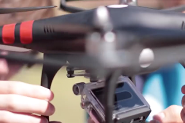 close up of students setting up drone and camera