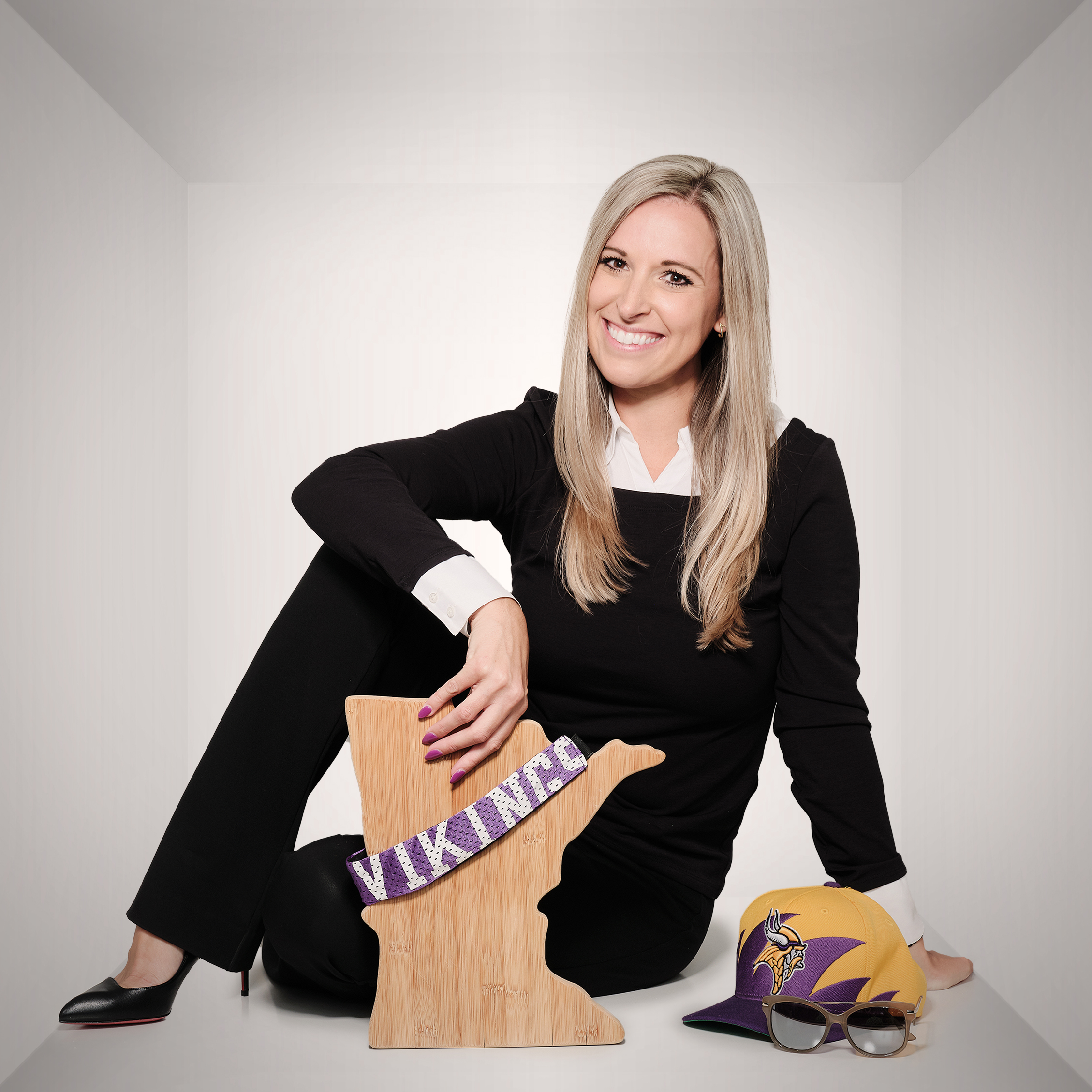 Brianna with a wood cut out of Minnesota that has a Vikings banner on it