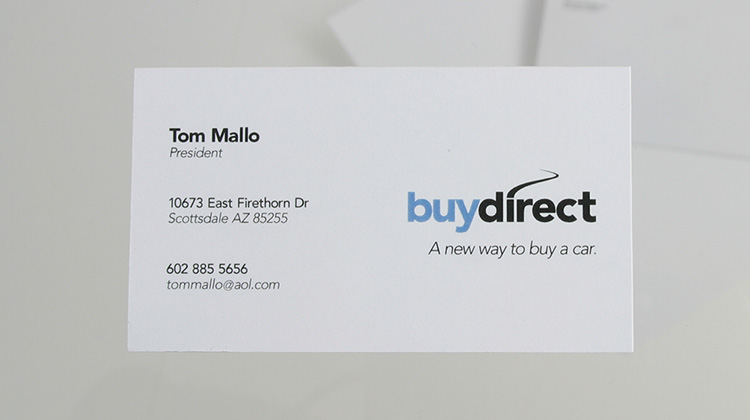 Automotive dealer's business card design is shown on a white card with a blue and black logo on the right-hand side with corporate information written in black on the left-hand side.