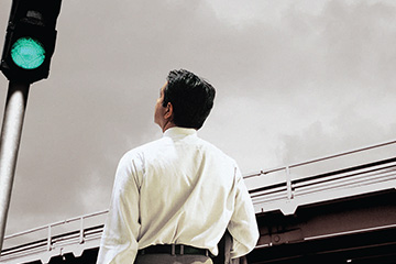 FabCom's contract management service brochure depicts an executive in white oxford shirt looking at a green light, which is a metaphor for enabling companies to safely hire 1099 contractors.