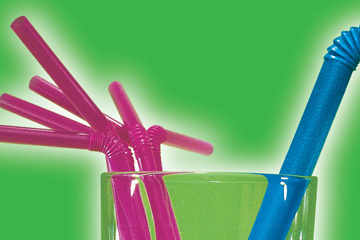 High-resolution zoomed-in image showing the intricate design detail and quality of a print ad FabCom designed. Image features the top of a glass cup containing pink and blue bendable straws.