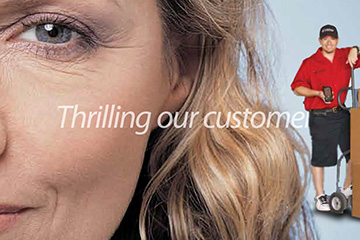 FabCom's sales enablement brochure closeup-image of female executive smiling and a delivery driver in red shirt.