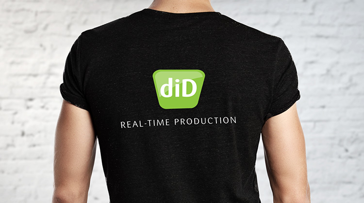 Image of a man wearing a black shirt with the Dynamic Imaging + Distribution logo created by FabCom printed on the back.