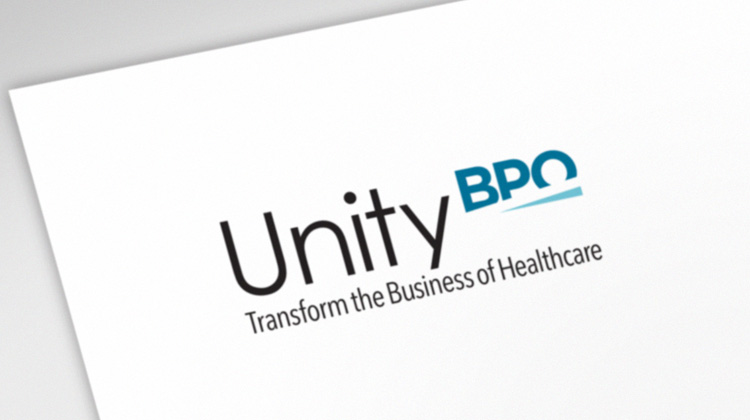 Front of a business card developed by FabCom for a health industry technology company that has the company's blue and black logo over a white background.