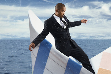 Image by FabCom for a health industry technology company's campaign that shows a man in a business suit standing in a paper boat on the ocean.