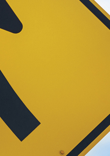 High-resolution zoomed in image showing imagery depth and detail of a tradeshow display created by FabCom. Display features a bright yellow street sign.