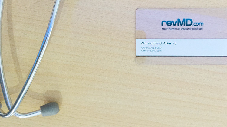 Image of a business card created by FabCom for revMD.com  alongside a close up of a stethoscope.