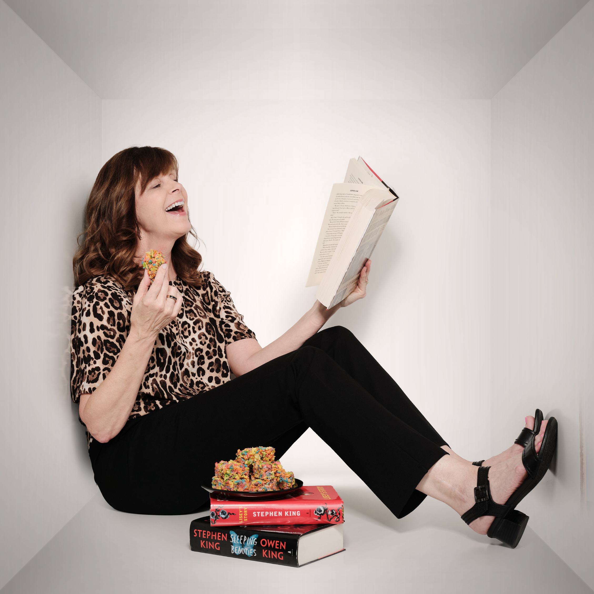 Jennifer laughing at a book