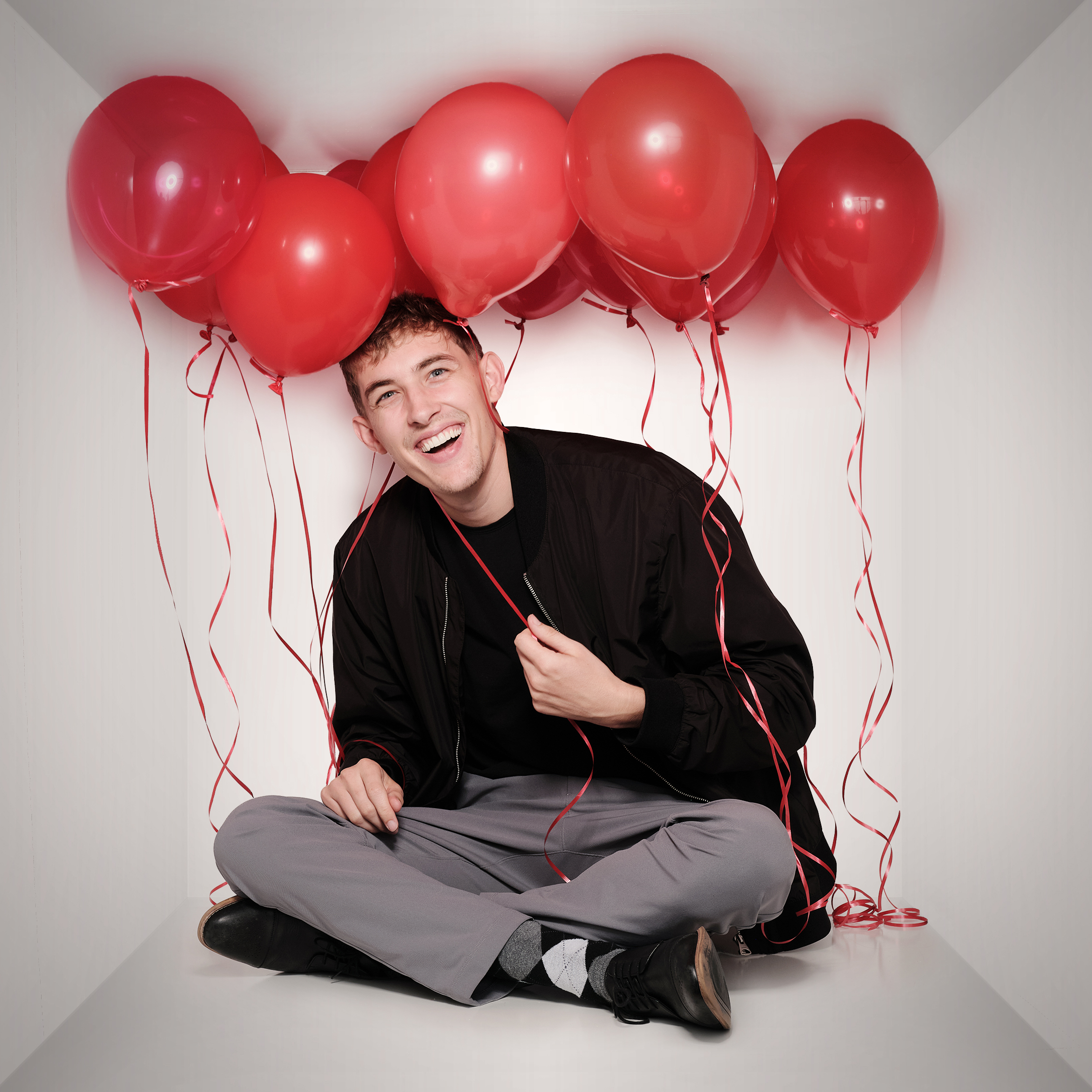Jordan smiling under balloons