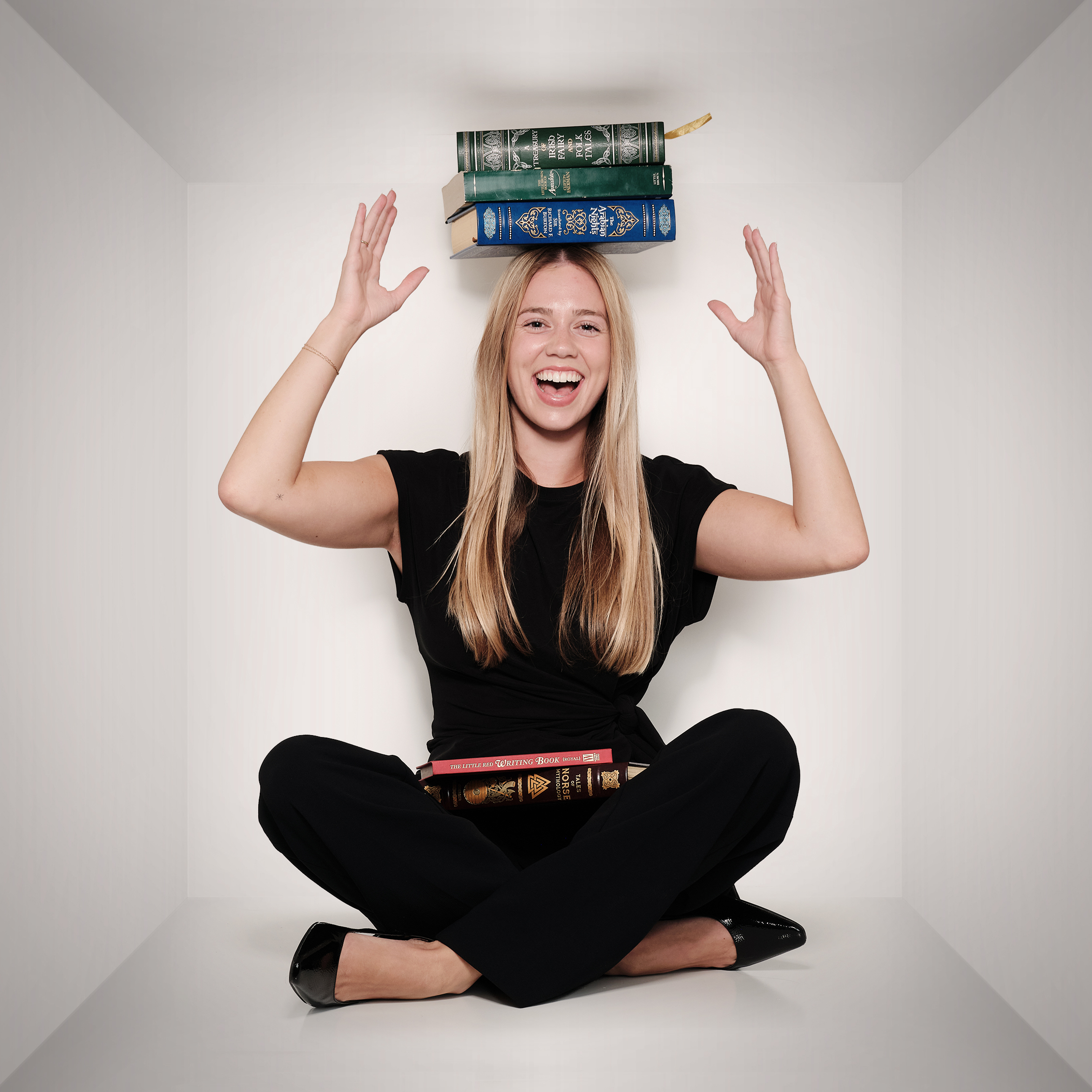 Katrina balancing books on her head