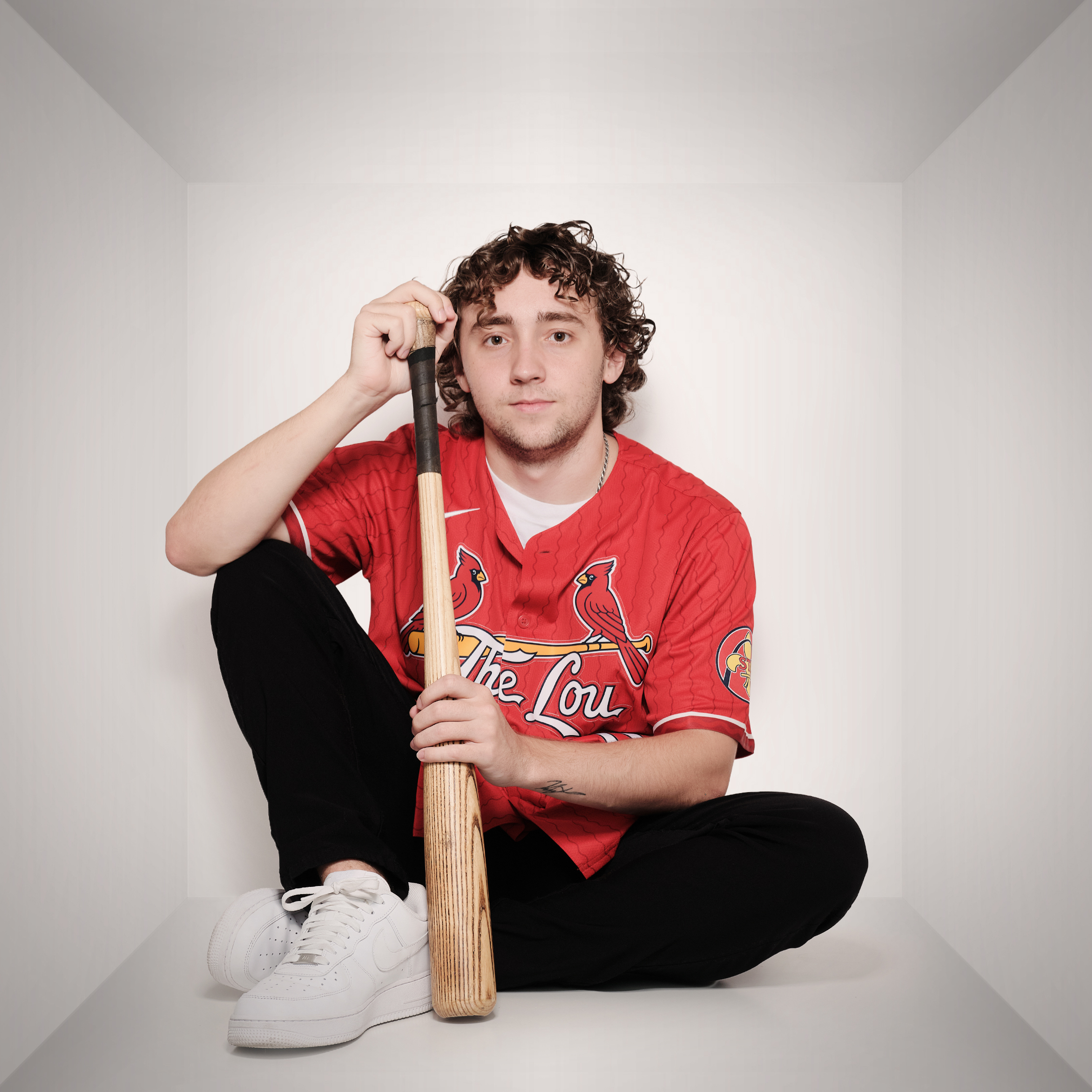 Michael leaning on a baseball bat