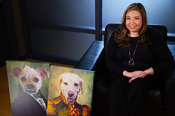 Monique sitting with dog paintings