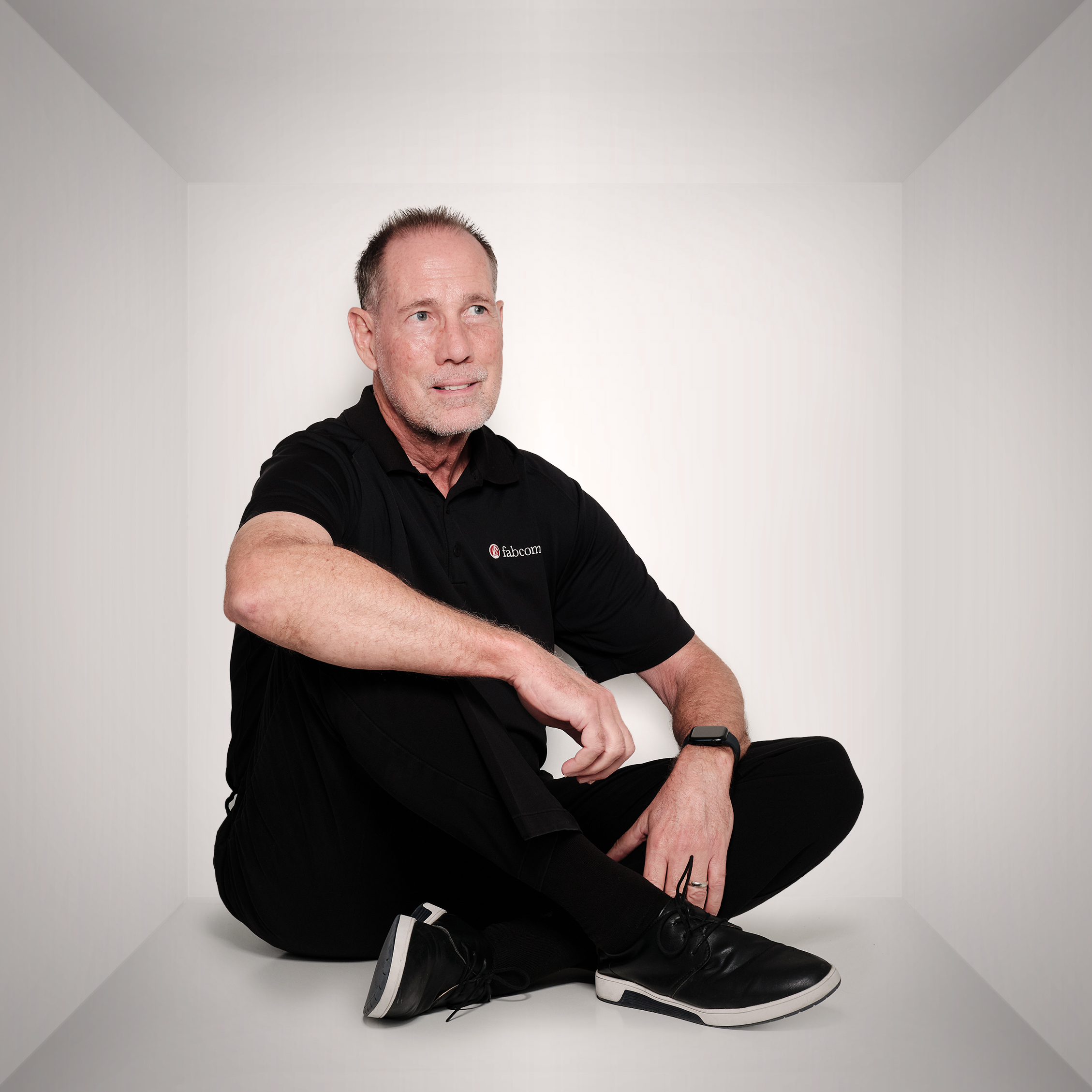 Mark sitting down smiling