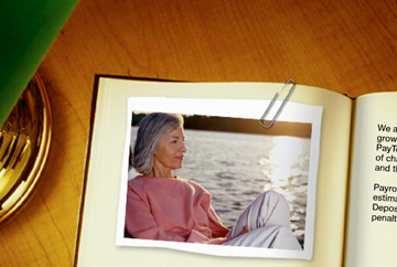 High-resolution zoomed-in image of a web page FabCom developed. Image features a digital book open on a page containing a polaroid of an elderly woman sitting by a lake.