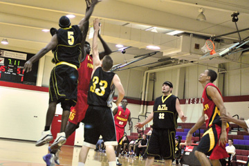 FabCom photographers captured pro basketball action in this image of players jumping for the basketball.