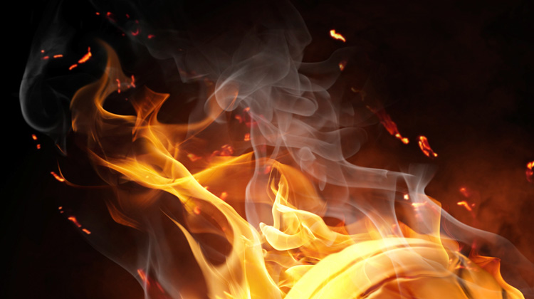 Zoomed in image showing design detail and quality of an image within the website FabCom developed for a high school athletics team. Images features a volleyball surrounded by flames.