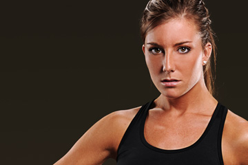 Zoomed in image showing photographic quality of an image within the website FabCom developed for a high school athletics team. Images features a female athlete in a black top.