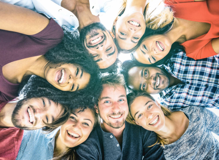 smiling people in huddle