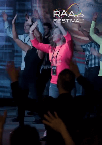 RAADfest attendees with hands up in the air cheering