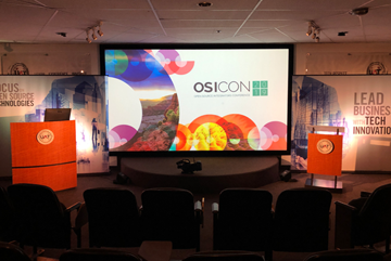 Conference stage with branding on projector screen