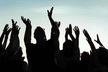 Zoomed in image showcasing design detail of a billboard developed by FabCom for a technology university featuring a crowd of people with their arms reaching above their heads.