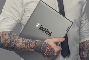 FabCom designed this image featuring a tattoo-sleeved man in a fitted white shirt and a trendy black tie holding a laptop branded with a university's tech conference logo to signify the target audience demographic of the event promotion.