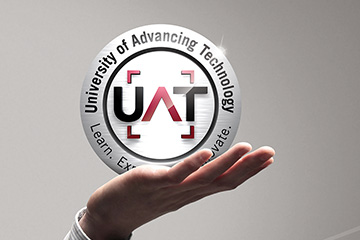 FabCom's 2D rendering of 3D tech university logo design held up by a human hand as if the logo is being presented by a person.