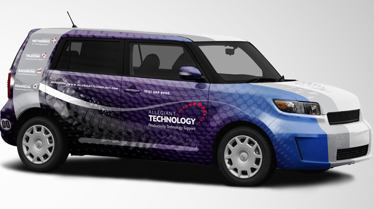Image of small SUV with advertising wrap for Allegiant Technology featuring the company logo and striped coloring.