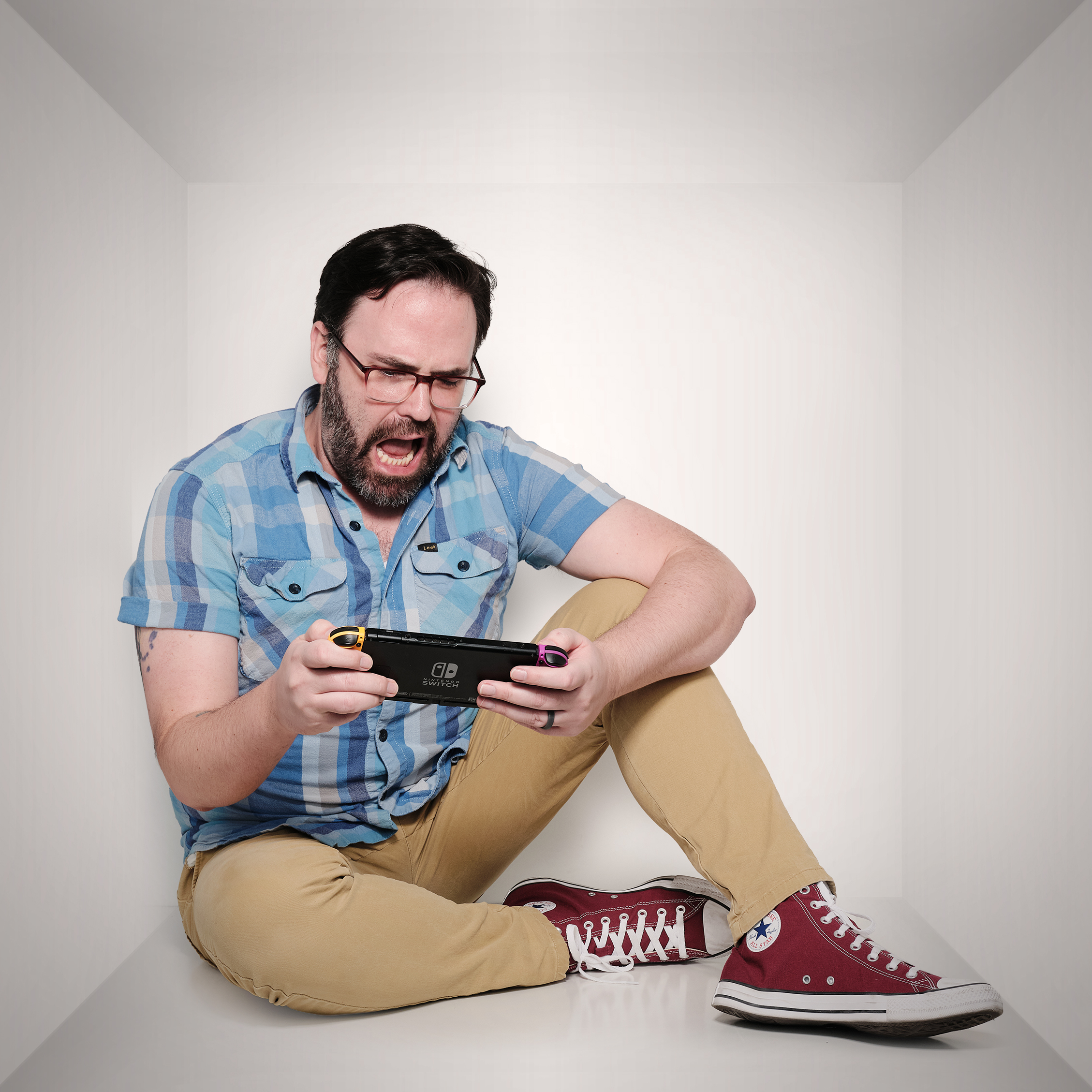 Trevor playing his Nintendo Switch in awww