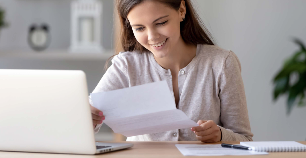 woman smiling at letter