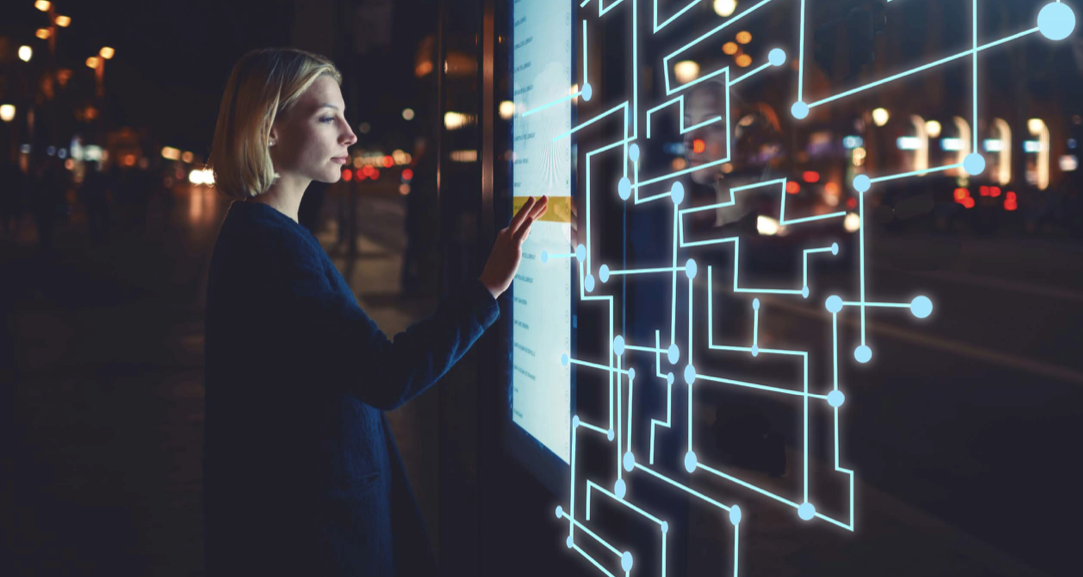 woman touching large touch screen